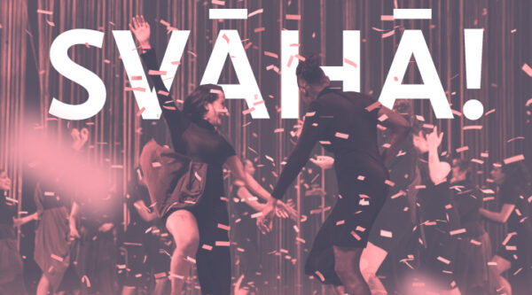 Text "Svaha!" at the top center of the image, featuring two performers dancing on stage together amidst confetti scattered all over the stage.